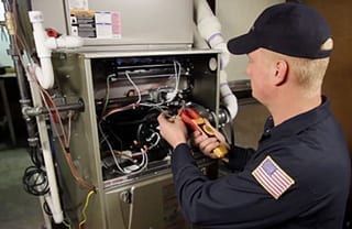 HVAC technician inspecting a gas furnace