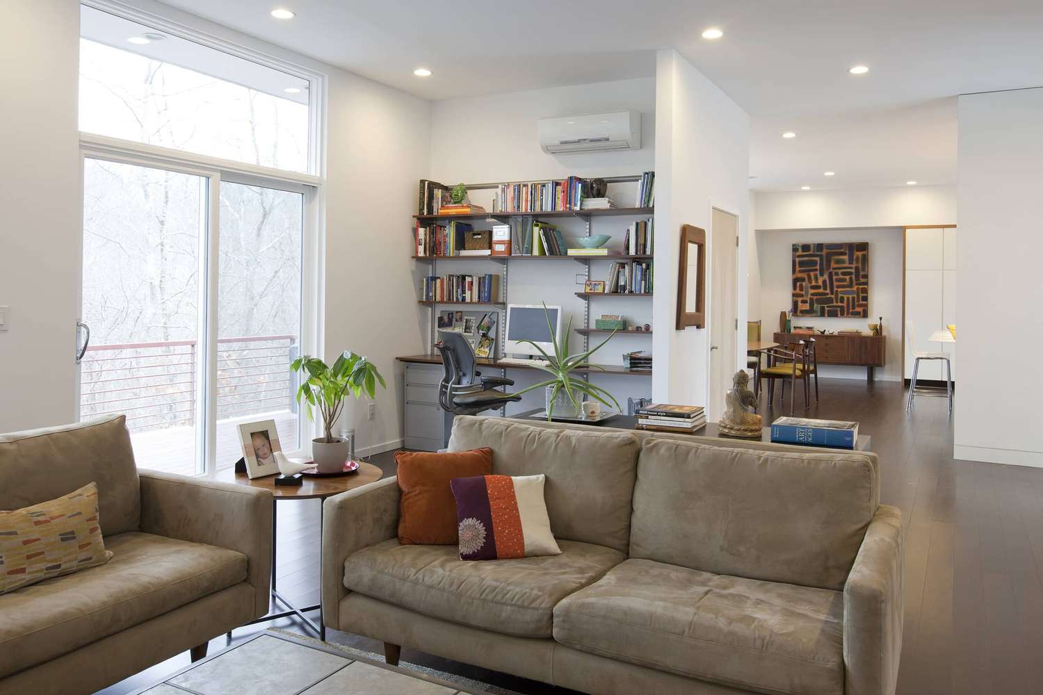Mitsubishi wall-mounted heat pump unit in a bright living room