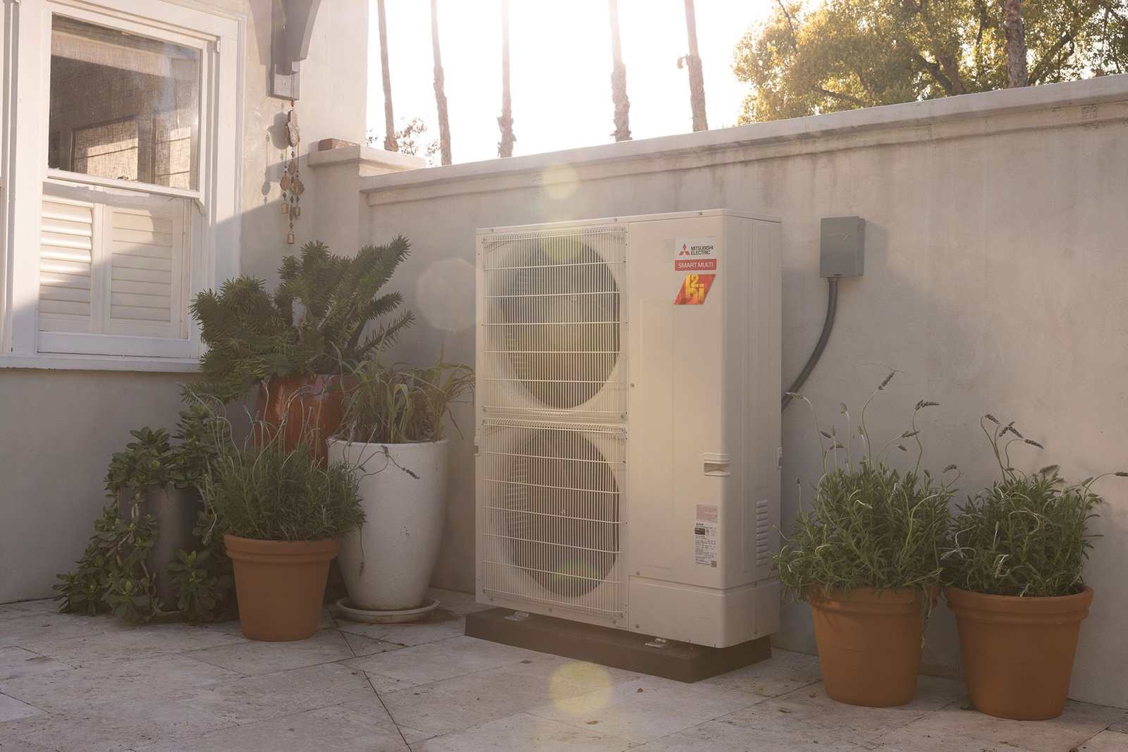 Mitsubishi Hyper-Heat outdoor unit beside a home patio