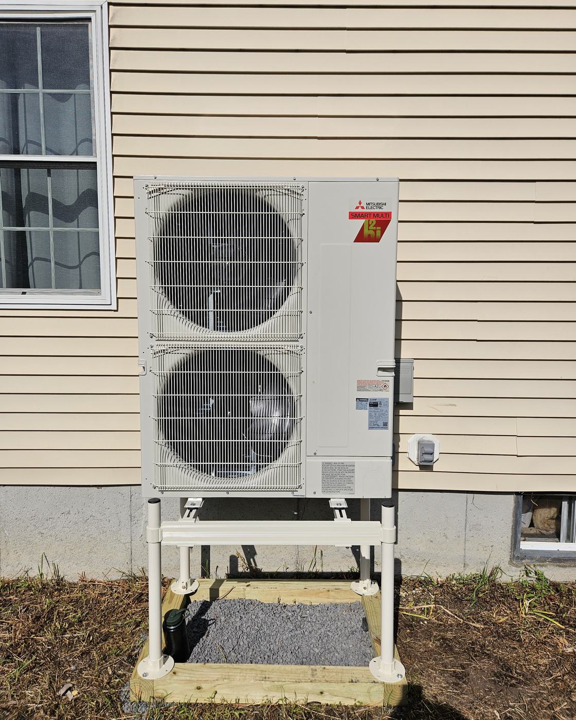 Mitsubishi Smart Multi Hyper-Heat outdoor unit on a stand with a gravel pad — whole-home multi-zone install by Superior CO-OP HVAC